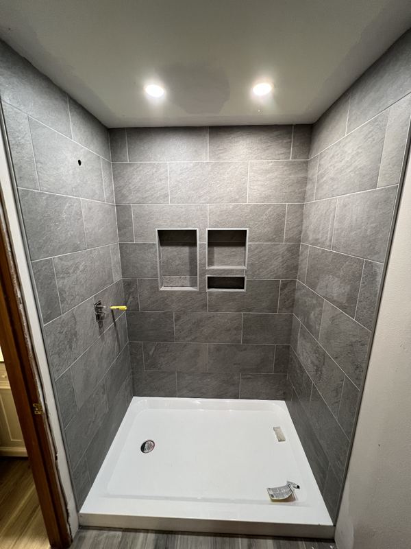 Grey tile shower with white base
