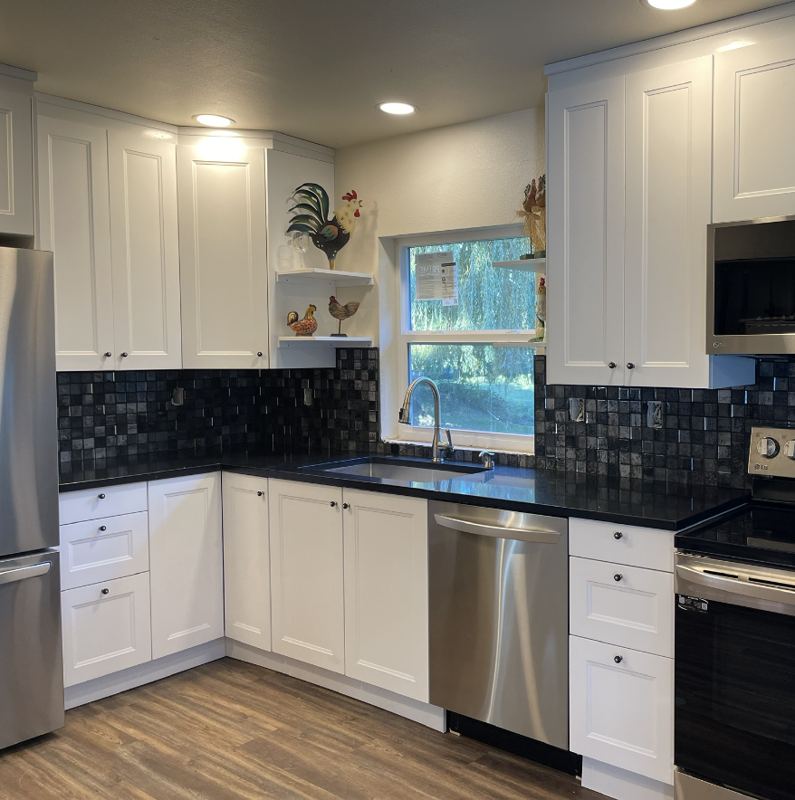 Kitchen with white cabinets and wood-look flooring