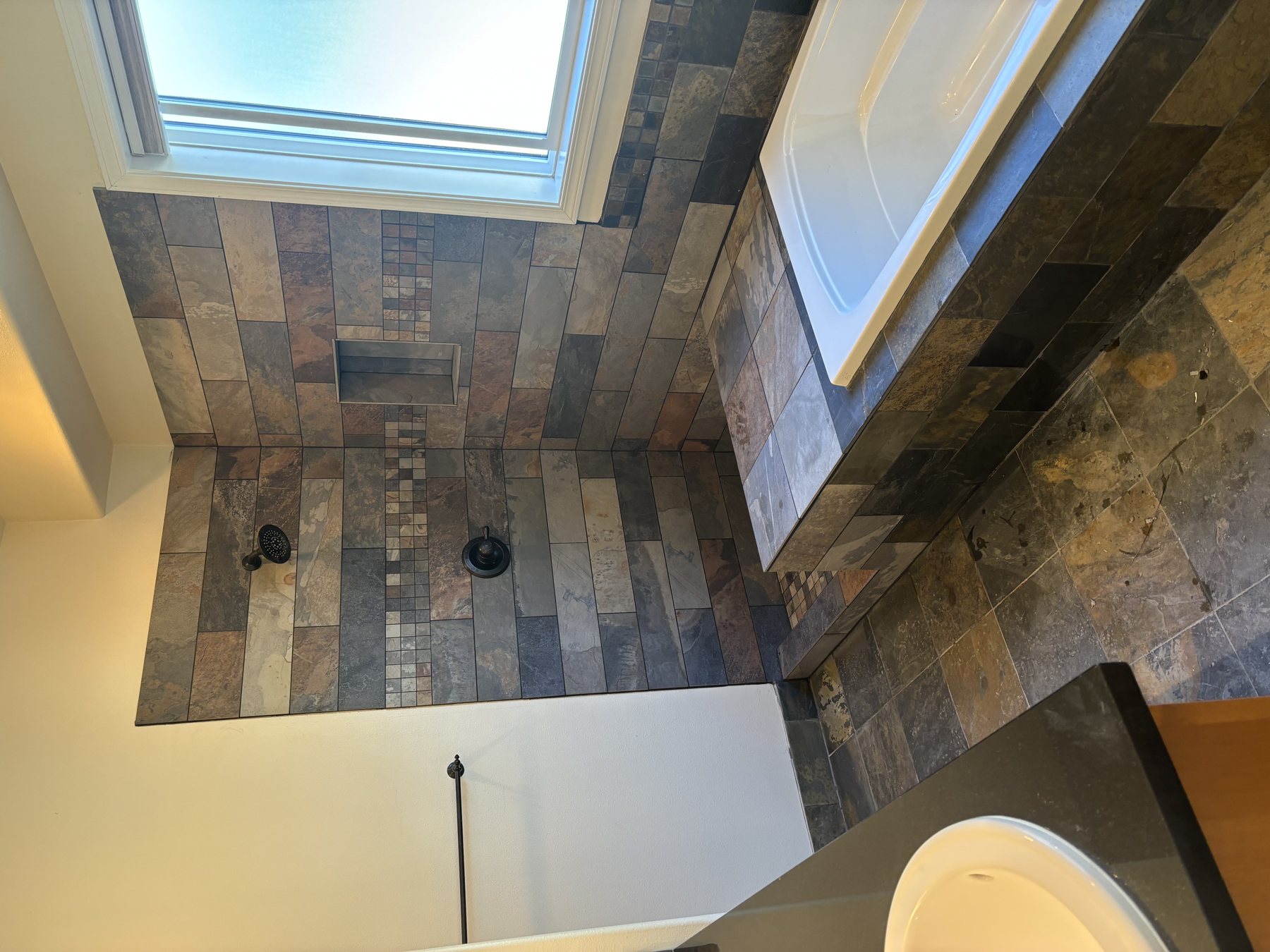 Slate tile flooring installed beneath a skylight