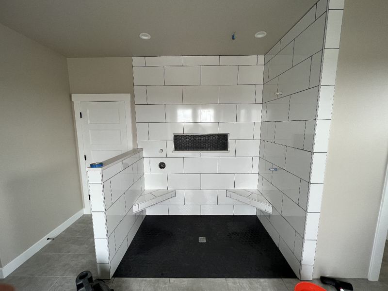 Bathroom with white subway tile and dark floor