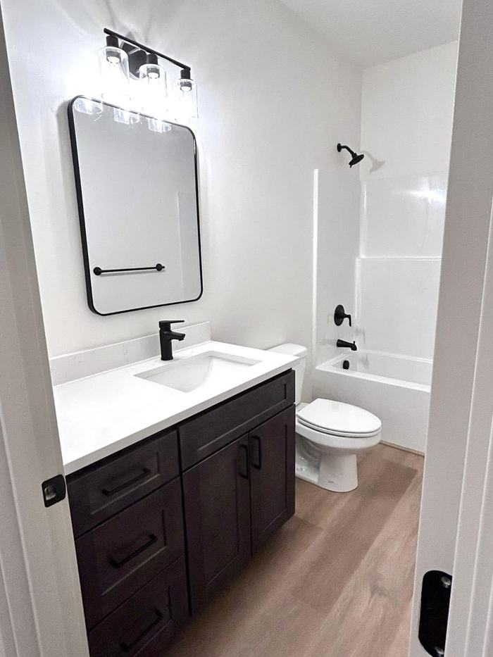 Dark vanity and tub